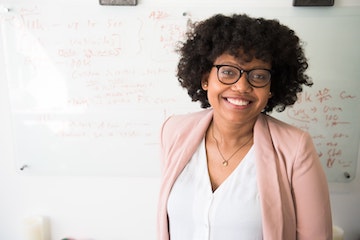 African American female wearing glasses posing for a picture